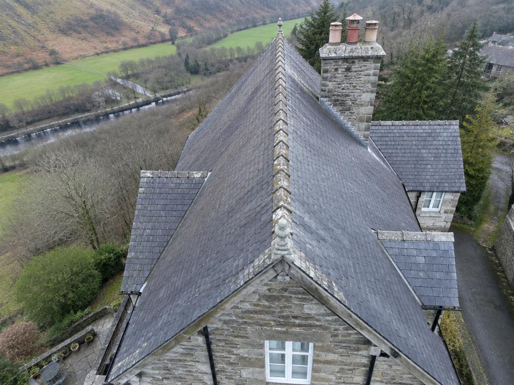 Illustrative example: aerial view of a steep slate roof showing ridge, valley and chimney detail